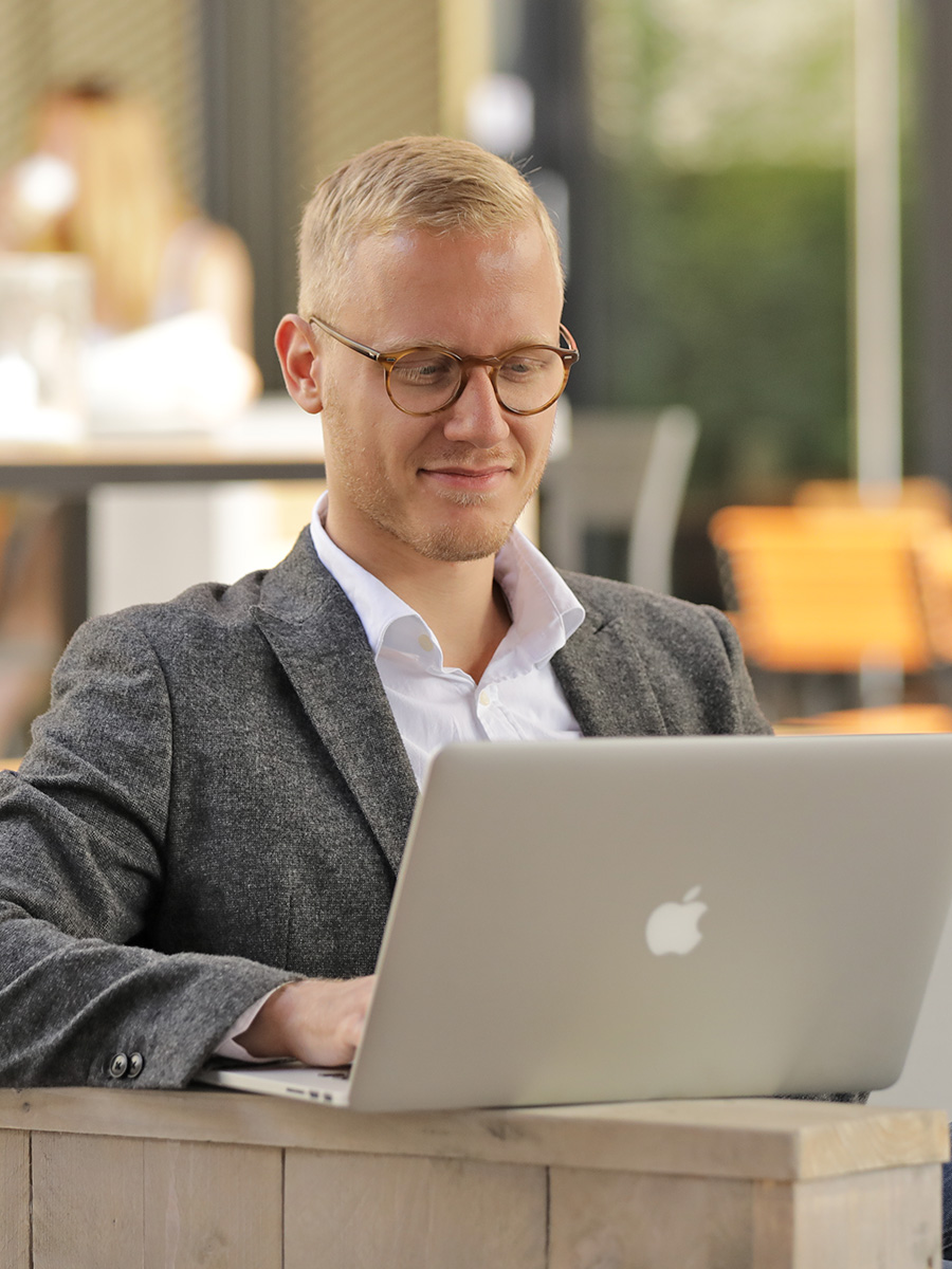 Eine Person auf der Terrasse mit einem Laptop